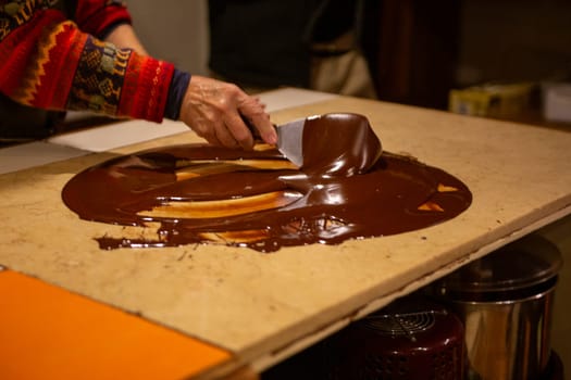 Chocolatier spreading chocolate as a demonstration