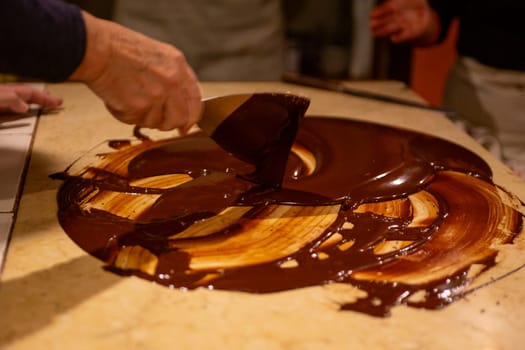 Chocolatier spreading chocolate as a demonstration