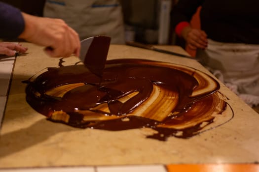 Chocolatier spreading chocolate as a demonstration