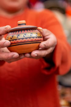 Peruvian Woman holding Souvenir container