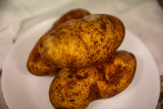 Three Russet Potatoes ready to be baked