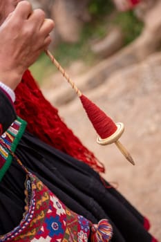 Spool of Red Dyed Wool demonstration by a Peruvian Woman