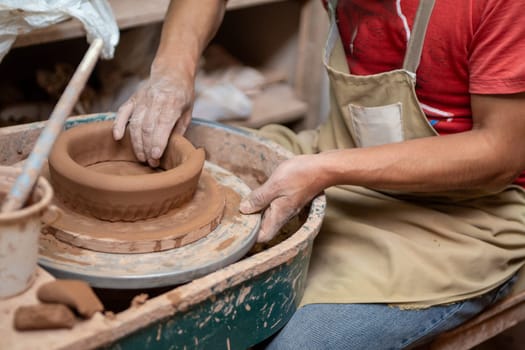 Peruvian Crafting a ceramic bowl to be sold
