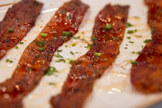 Row of Candied Bacon freshly made with syrup