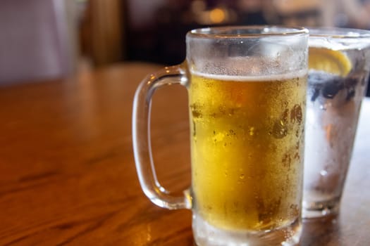 Mug of beer and waterat a bar