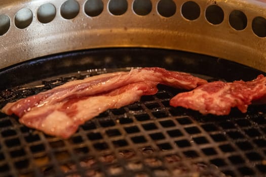 Pork Sizzling on the Grill at a Japanese BBQ restaurant
