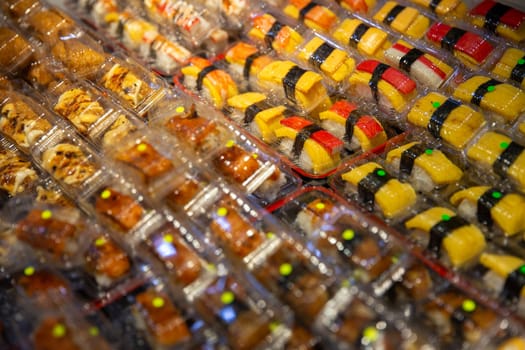 Lots of mini sushi at a food stall