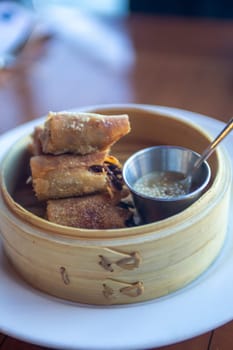 Fried Spring Roll served in a bamboo steamer