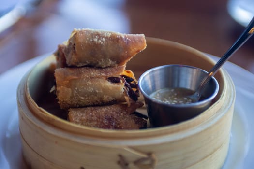 Fried Spring Roll served in a bamboo steamer