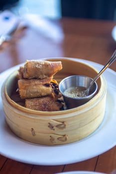 Fried Spring Roll served in a bamboo steamer