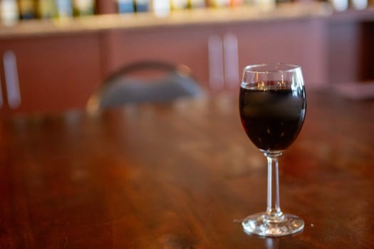 Glass of red wine on a bar