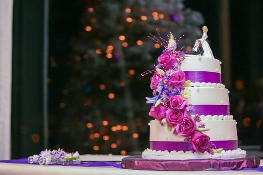 Three tiered Purple Wedding Cake with funny cake topper