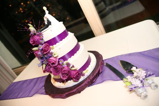 Three tiered Purple Wedding Cake with funny cake topper