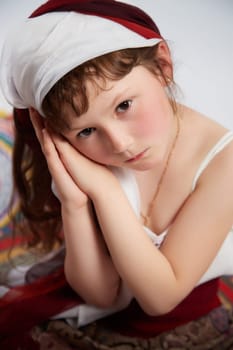 Portrait of Little girl in a stylized Tatar national costume on a white background in the studio. Photo shoot of funny young teenager who is not a professional model