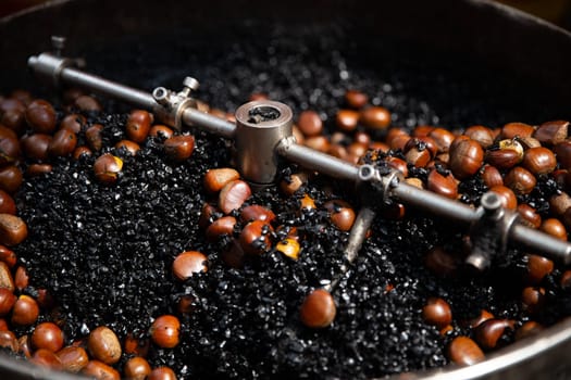 Rotating Roasting Chestnuts Swirling in Coal