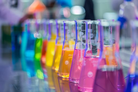 Colorful chemical solutions in laboratory flasks for science experiment, research and development or education