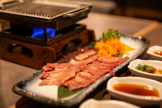 Wagyu Beef on a BBQ with Condiments for dipping
