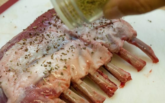 Seasoning Raw French Rack of Lamb