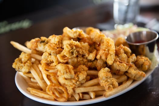 Fried Calamari and french fries served with cocktail sauce