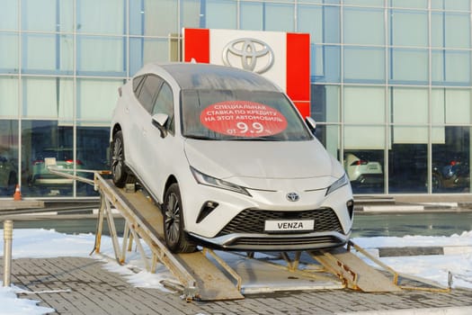 Tyumen, Russia-March 02, 2024: Toyota Venza is showcased on an inclined ramp outside a showroom.