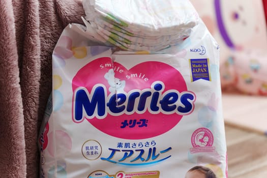 Tyumen, Russia-March 02, 2024: Detailed close-up of a bag of Merries baby diapers, showcasing the brand logo and packaging design.