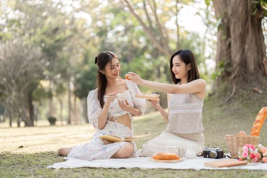 Two best friend do holiday activities, eat snacks, read books, and have picnics in the park to relax together..