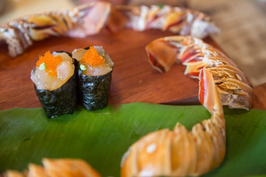 fresh lobster sushi with lobster tails going around