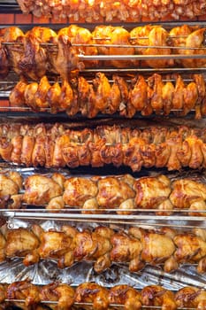 Rotisserie chicken on a rack roasting