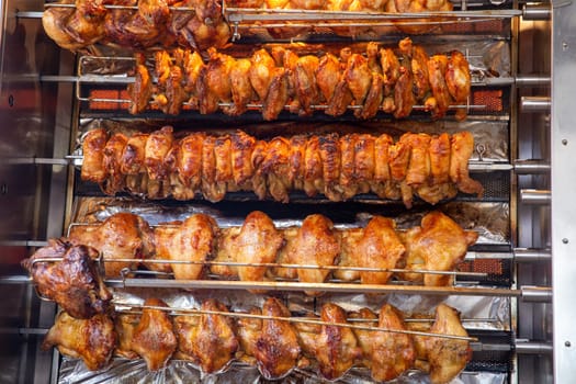 Rotisserie chicken on a rack roasting