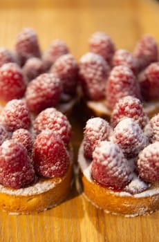 Raspberry Mini tarts shot vertically at a bakery