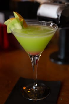 Green apple martini garnished with apples