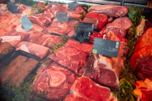 Variety of raw meat for sale at a butcher