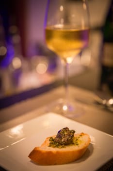 Single Escargot with wine and sliced bread