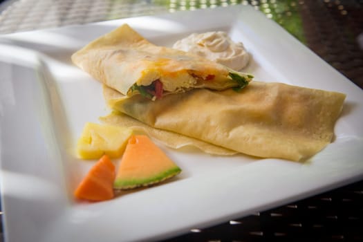 Sliced Stuffed Breakfast Crepe with eggs, Spinach and Cheese