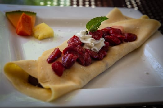 Strawberry Crepe with Chocolate Filling topped with whip cream