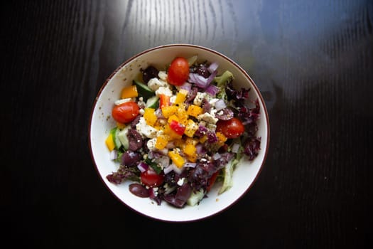 Small greek salad on a wooden table