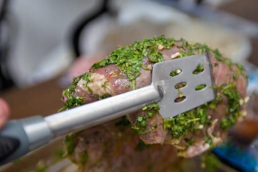 Grabbing marinated steak to be thrown on the grill