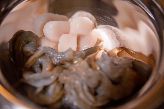 Raw shrimp and Scallops in a bowl to be cooked