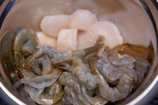 Raw shrimp and Scallops in a bowl to be cooked