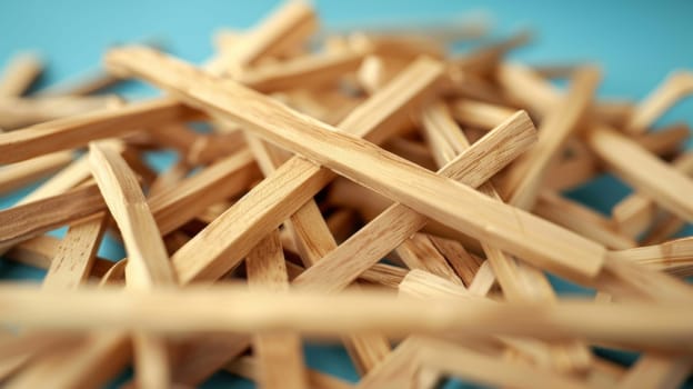 A pile of wooden sticks on a blue background