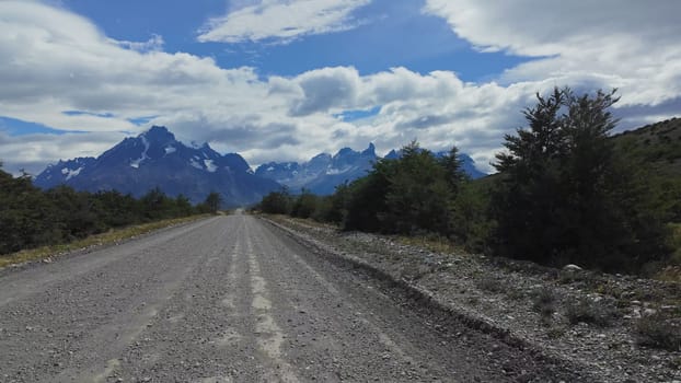 Hyperlapse video showcases the journey on a gravel road to Torres del Paine, featuring its iconic snowy peaks and glaciers.