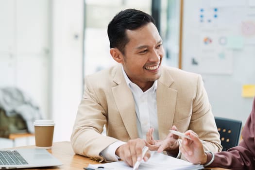 Business man executive discussing project plan with employee in boardroom.