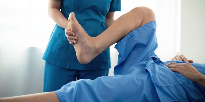 Healthcare, physiotherapist and patient with foot injury, stretching and recovery with treatment, healing or care. physical therapy or consultation.