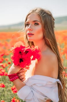 Woman poppies field. Side view of a happy woman with long hair in a poppy field and enjoying the beauty of nature in a warm summer day