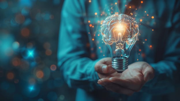 A person holding a light bulb with glowing brain inside