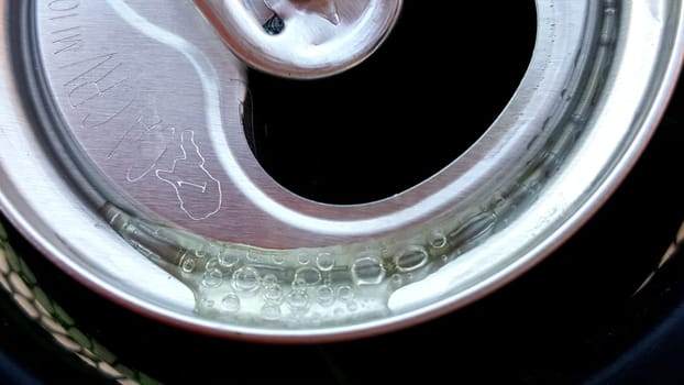 Soda Bubbles on Metal, Top of Open Soda Can . High quality photo