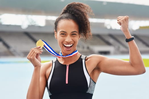 Sports, victory and portrait of woman with medal for winning, champion and race at stadium. Fitness, athlete and person with gold award at competition for success, celebration or achievement in Paris.