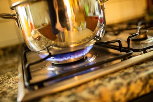 A large pot bubbles over a hot stove, a universal scene of cooking, filled with the anticipation of a delicious meal.