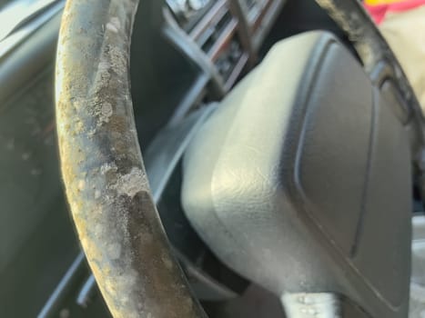 Close-up of an aged and rusted automobile steering wheel.