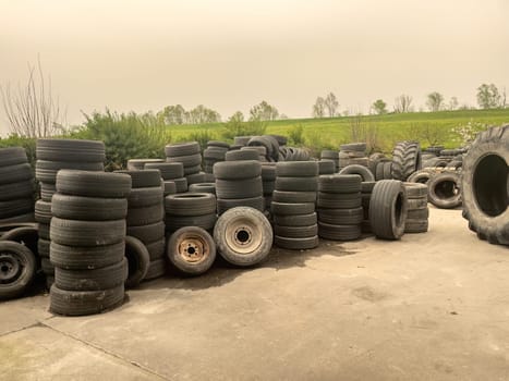 Piles of used tires ready for disposal. Environmental waste concept.